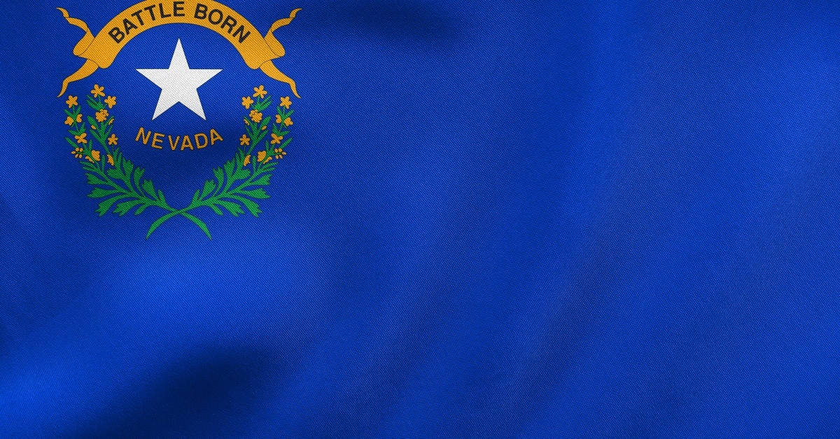 Close-up of the Nevada state flag, which features a large section of blue and the words "Battle Born" and "Nevada."